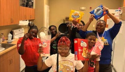 A group of people holding food.