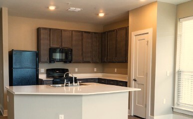 A kitchen with a white island.