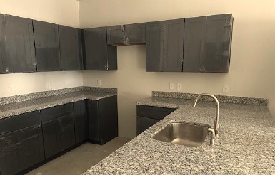 Kitchen with cabinets, counters, and sink.